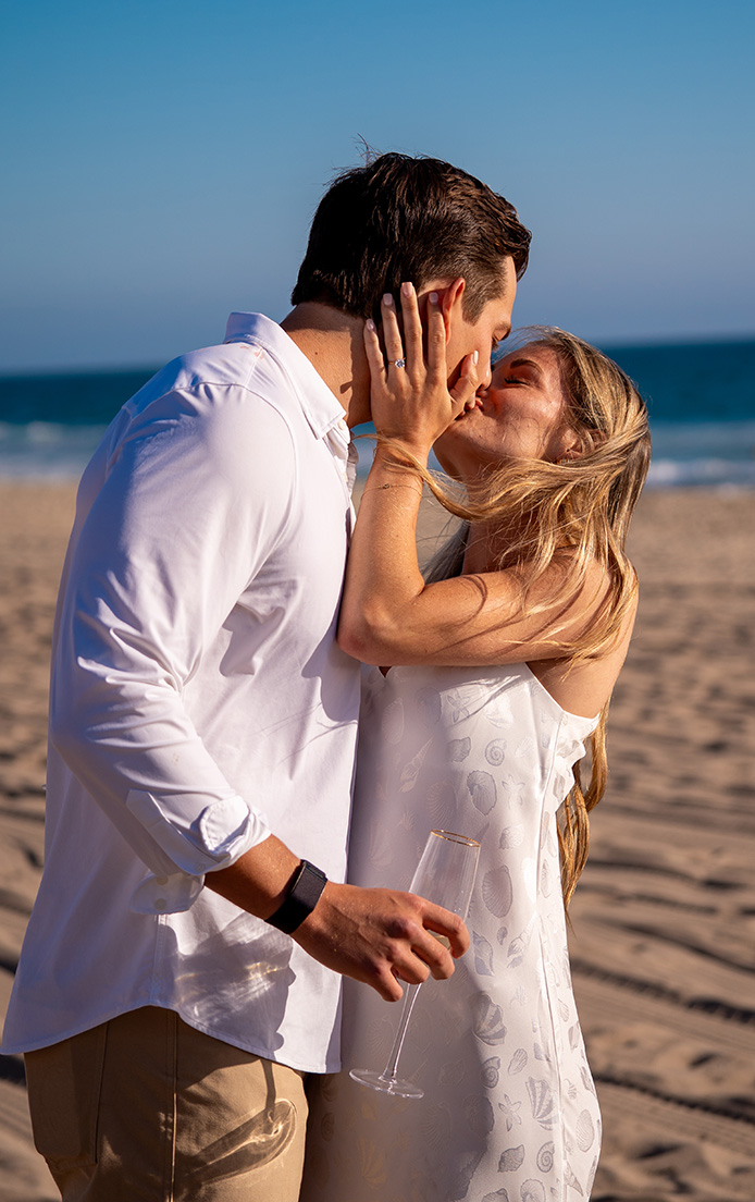 The couple kissing after the proposal